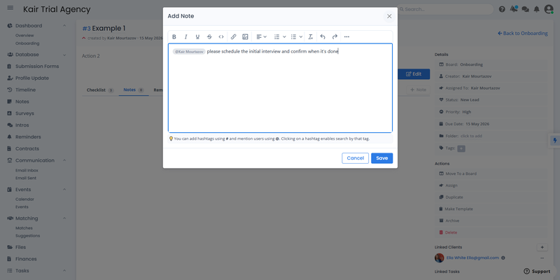 SmartMatchApp task Notes panel showing an @mention message &mdash; "@Kair Mourtazov please schedule the initial interview and confirm when it's done" &mdash; demonstrating asynchronous team communication inside a matchmaking CRM task