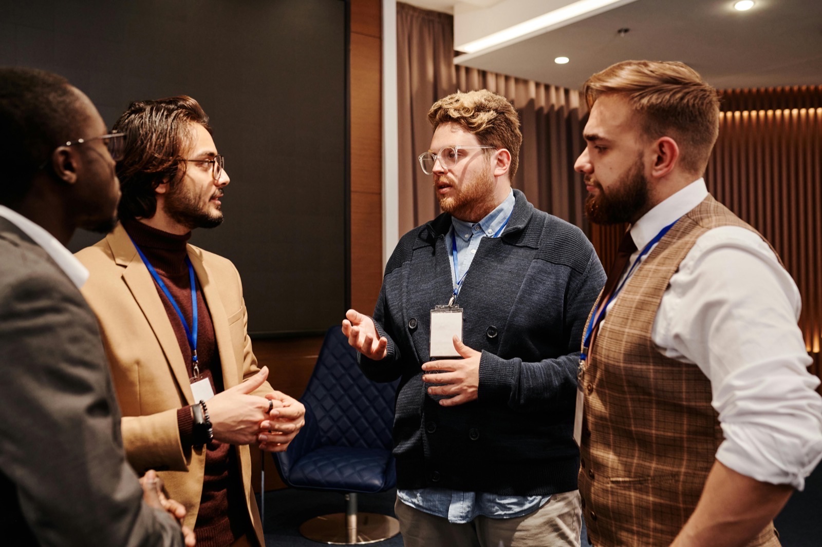 three guys talking at networking event